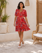     Robe courte imprimée rouge avec décolleté V, manches ballon et volants au bas